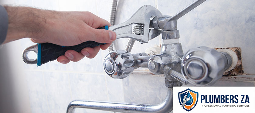 Plumber installing a bathroom faucet during professional plumbing service in Gauteng